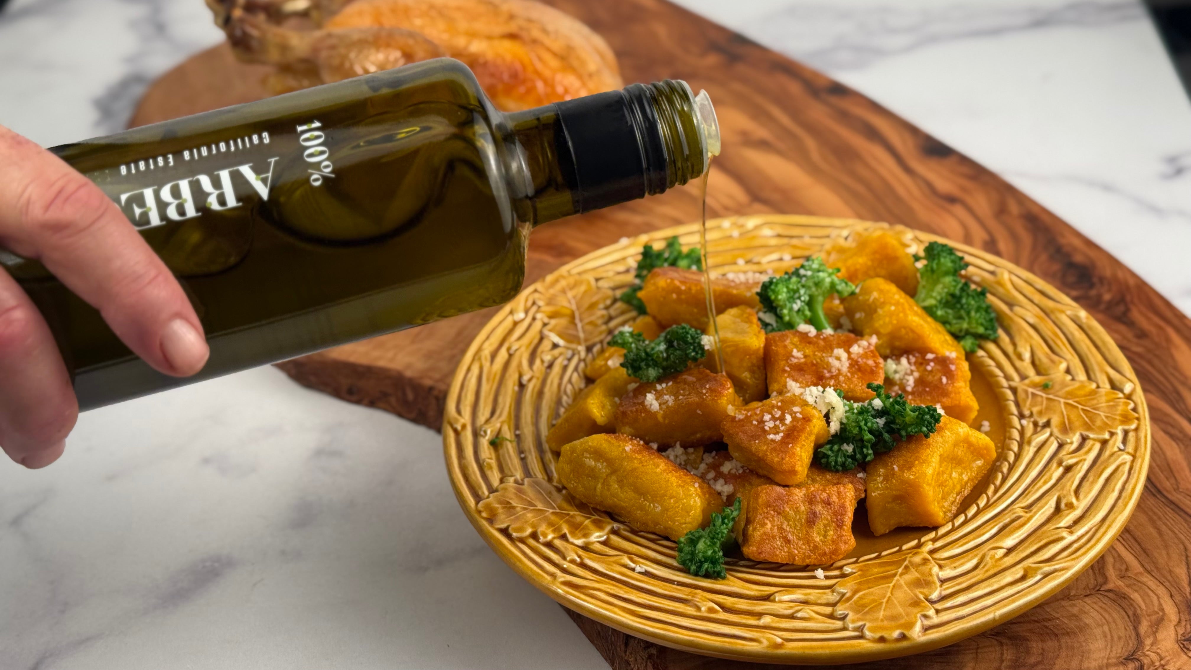 Lucero Arbequina EVOO is poured over a plate of crispy Butternut Squash Dumplings