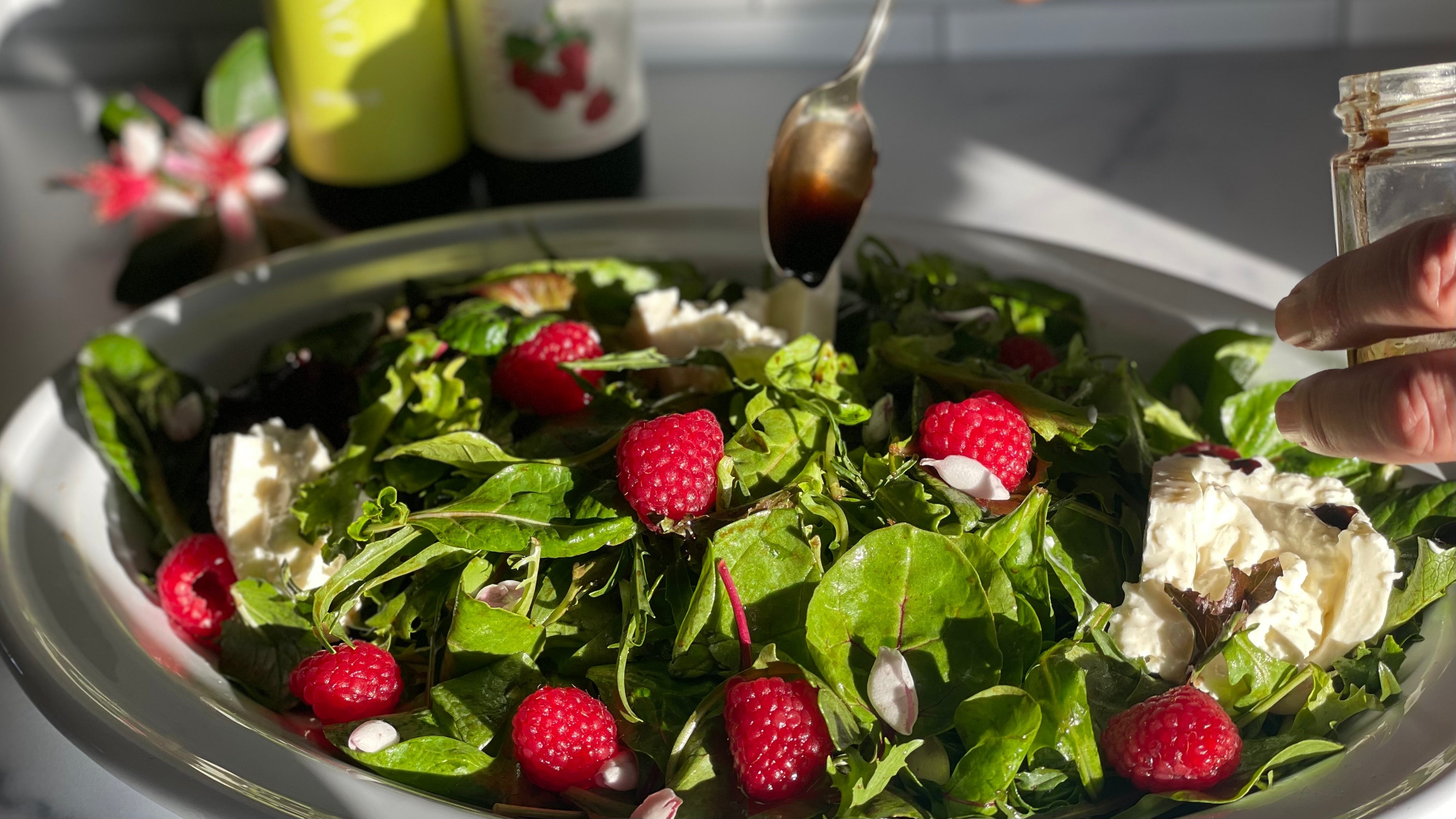 Spring salad with fresh raspberries and burrata.