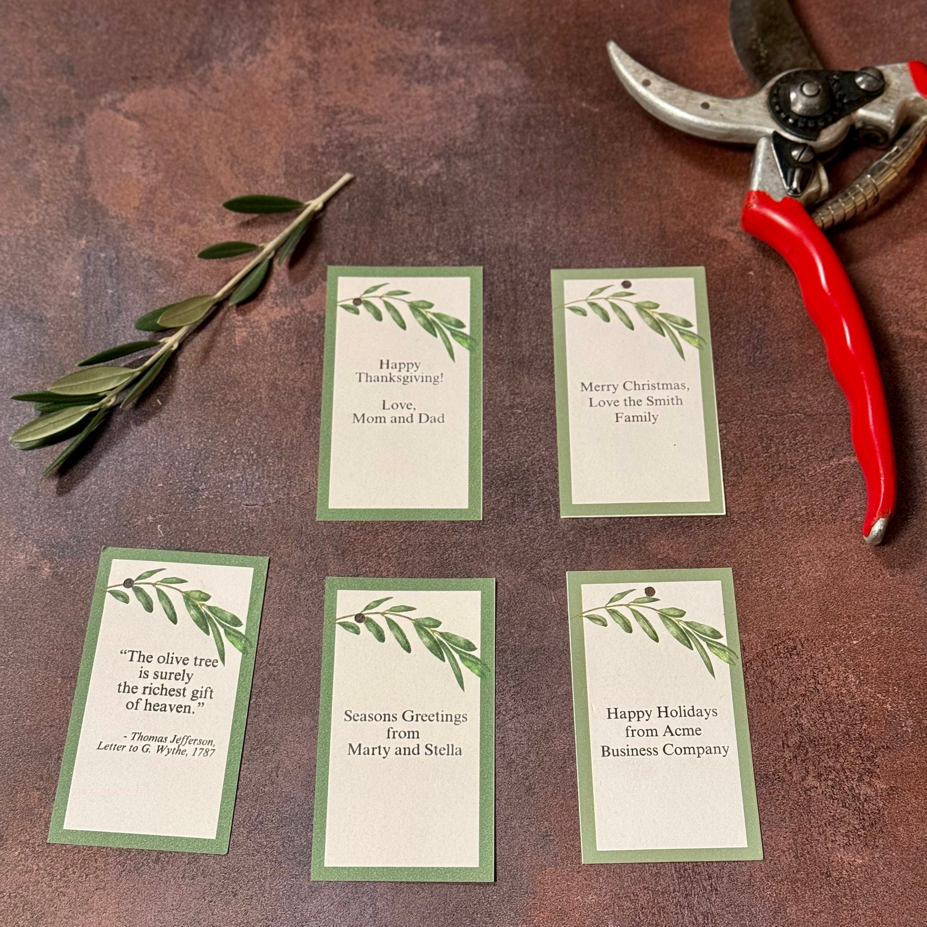 Examples of gift tags convey greetings for Thanksgiving and Christmas along with more generic ""seasons greetings" and "happy holidays". The Thomas Jefferson quote about olive trees as a gift is also shown.