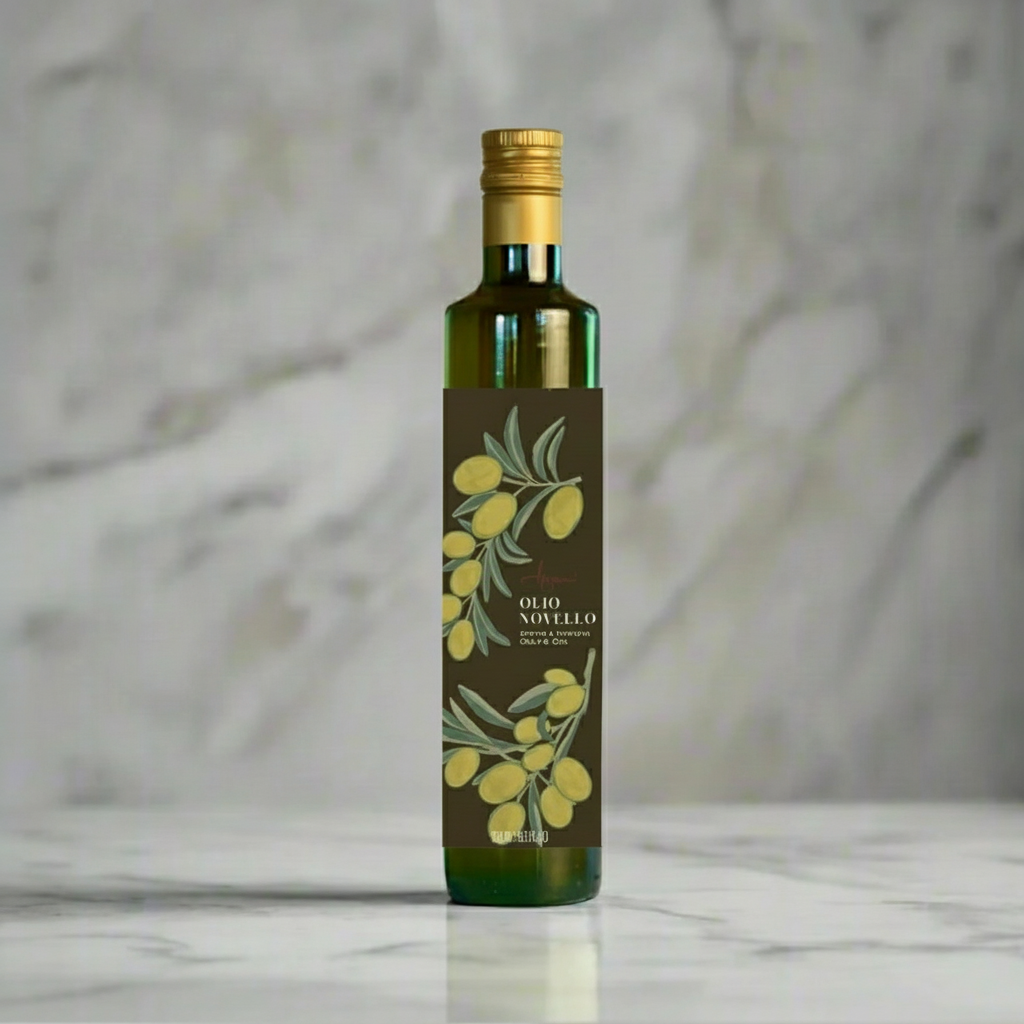 Bottle of olive oil with a label featuring olive branches on a marble surface.