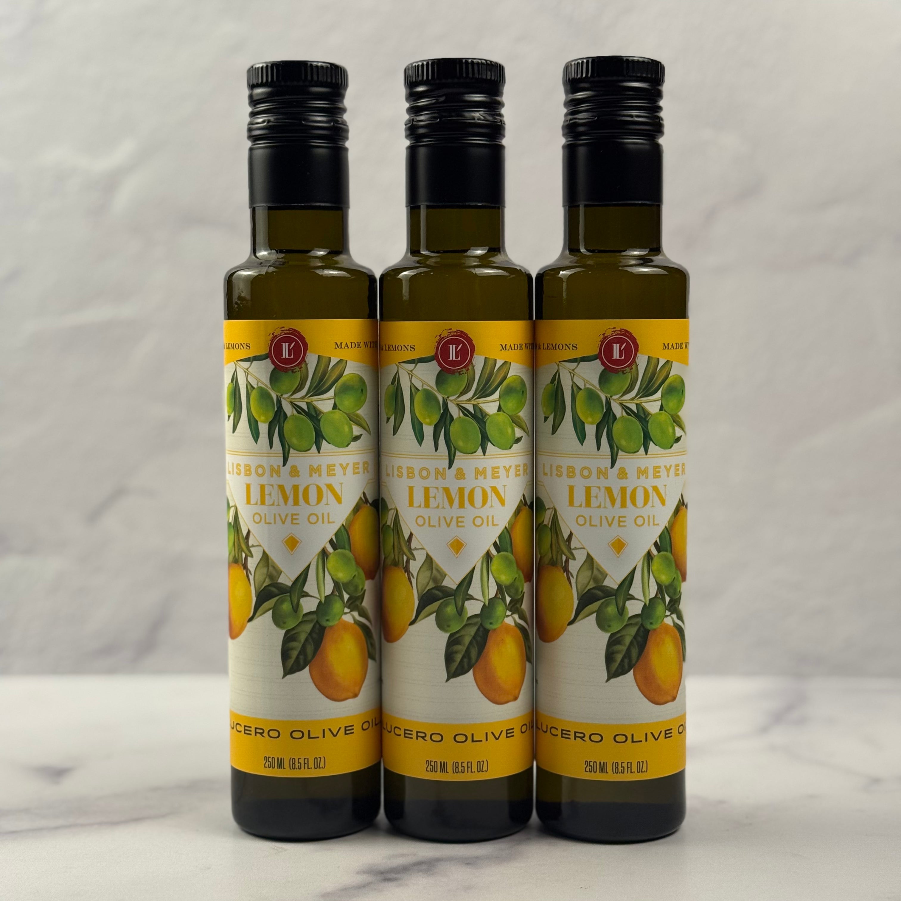 Three 250 ml Bottles of Lucero Lemon Olive Oil are shown in a marble Kitchen