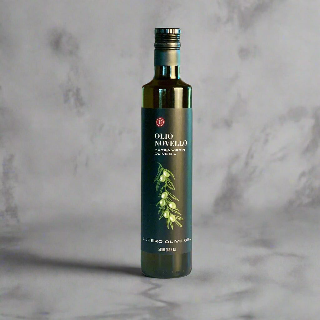 A single bottle of Olio Novello on a copper and marble counter top