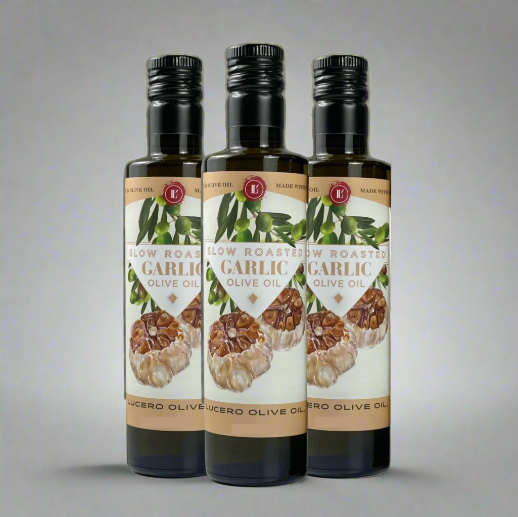 Three bottles of Lucero Roasted Garlic Olive Oil are shown on a plain background