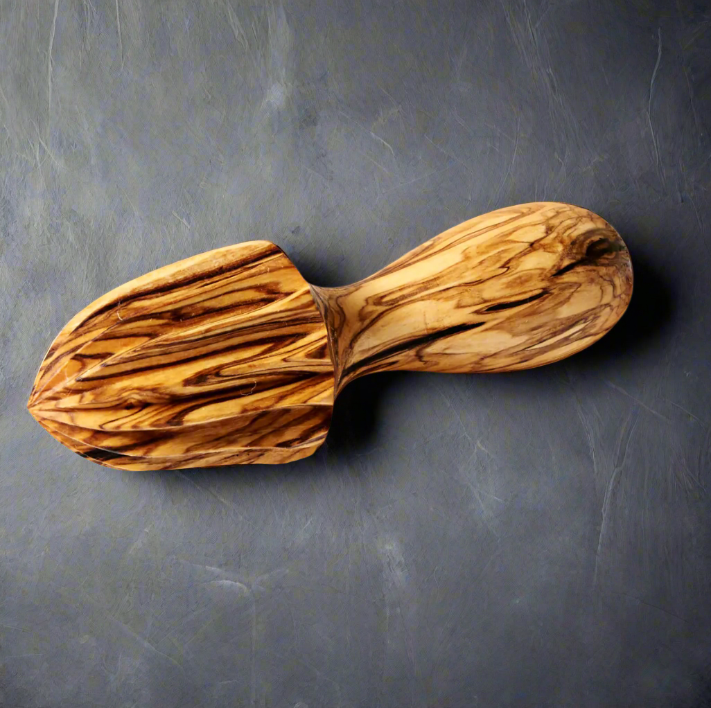 Vividly marked handheld citrus reamer has a soft rounded handle and deep grooves for juicing.