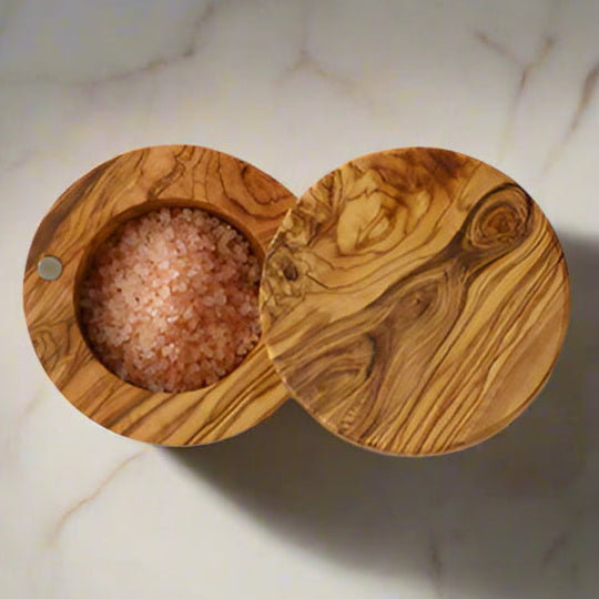 Olivewood salt box shown with hinged cover open.