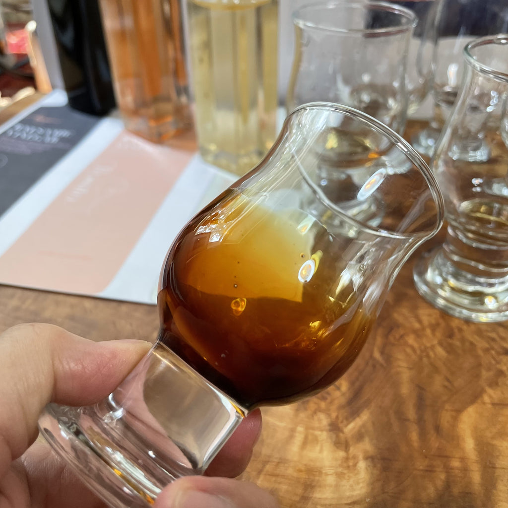 Liz is holding an official Balsamic Vinegar tasting glass from the Consorzio in Modena which she uses to assess and ultimately approve vinegar.