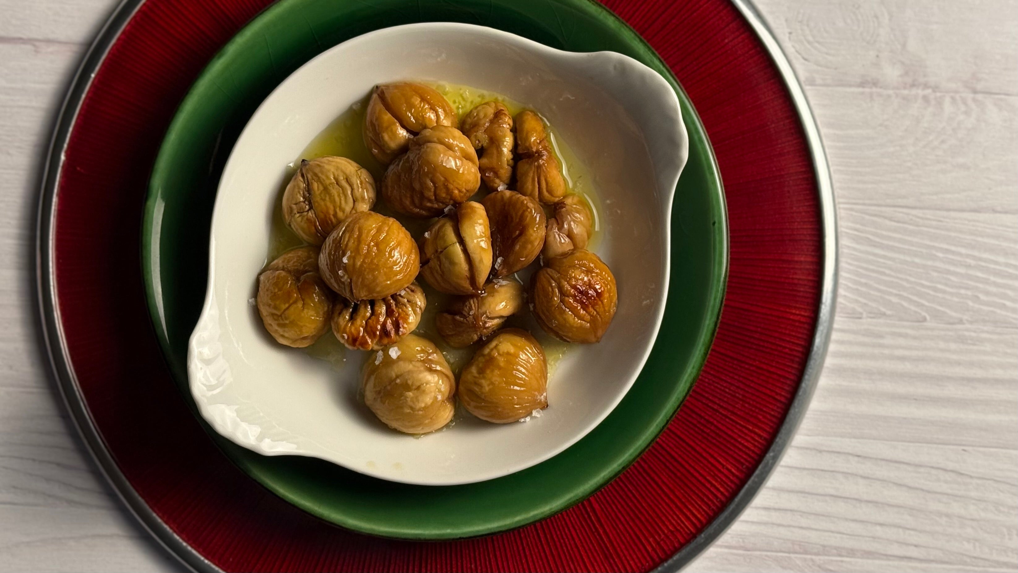 A dozen roasted chestnuts are piled artfully into a delicate round French porcelain gratin. They glisten with a fresh pour of Lucero Olio Novello and sparkle from a pinch of Jacobsen's Flake Salt.