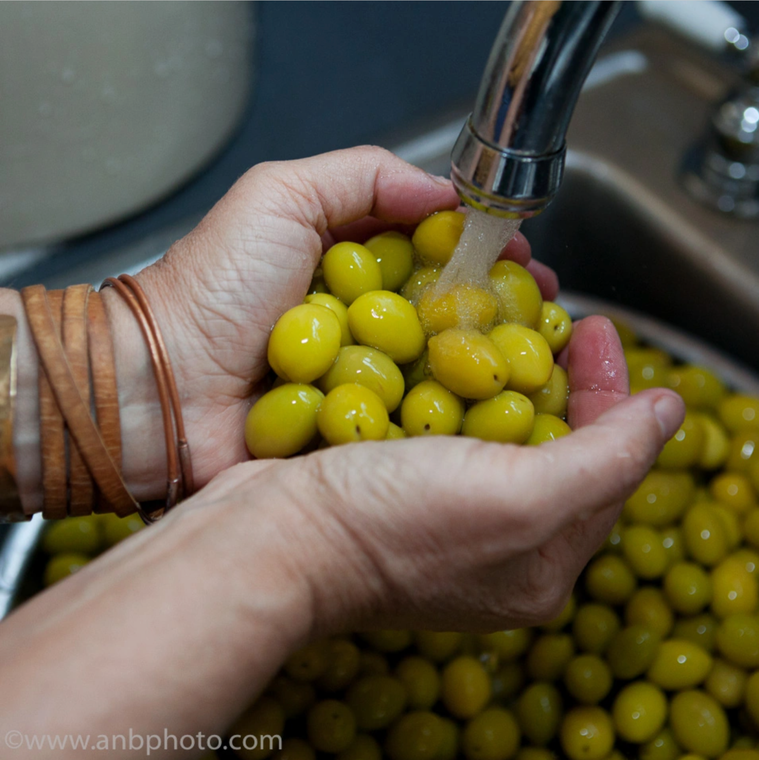 Angie rinses olives as part of the home cure process