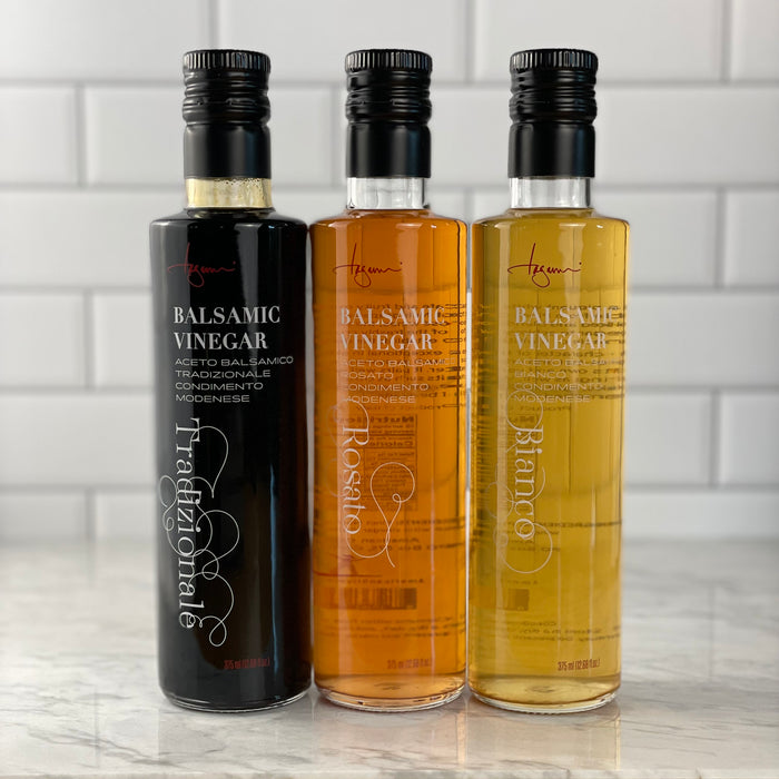 Traditional, Rosé, and White Balsamic Vinegars in a white tile kitchen