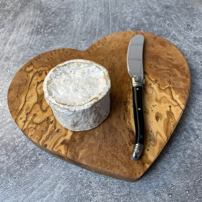 Small brie and spreader knife on heart shaped olivewood board