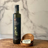 A single bottle of Olio Novello is shown with two olivewood dipping bows and the mini slide tin of Jacobsen's salt.
