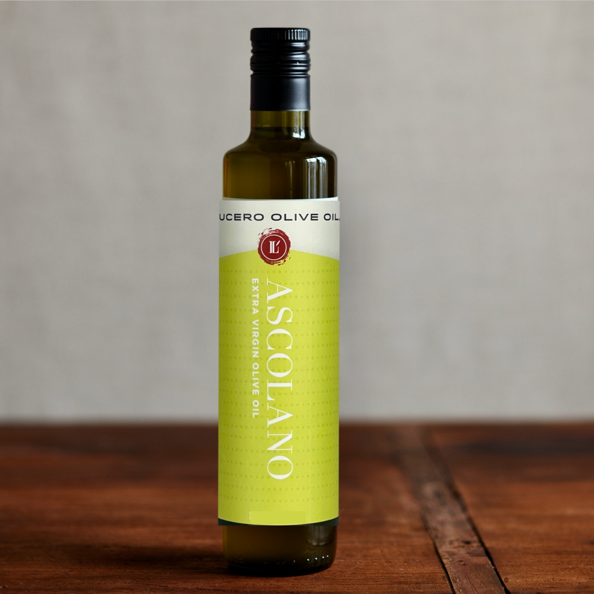 A single bottle of 500 ml Ascolano EVOO shown on a wooden table