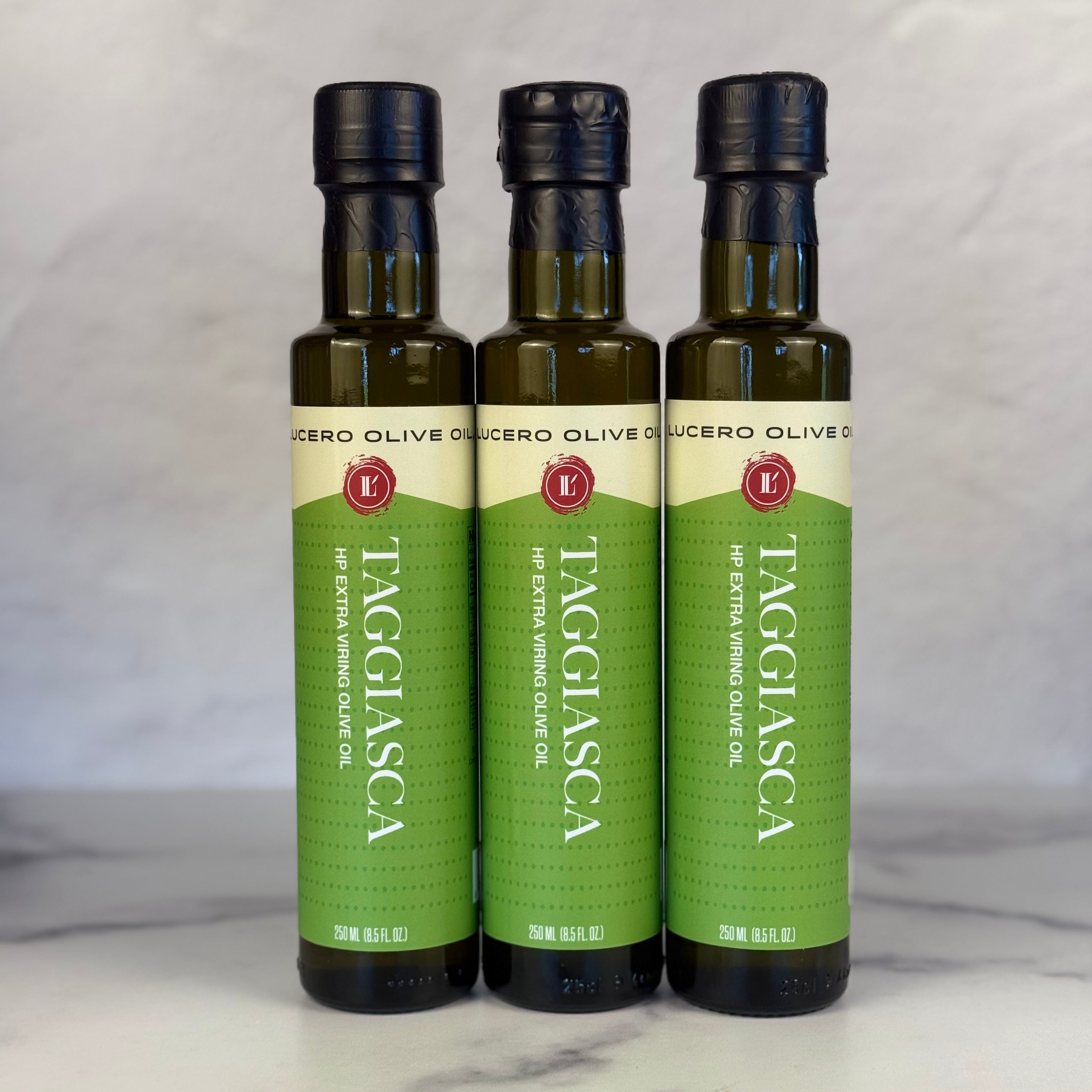 Three bottles of Lucero Taggiasca high polyphenol extra virgin olive oil on a white background