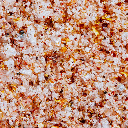 Extreme close up of Jacobsen kosher salt liberally flecked with the Sichuan pepper and chili