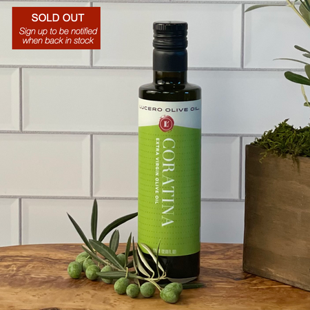 A bottle of Coratina EVOO is shown with some fresh coratina olives and a sign advising this variety is sold out, but to click through to ask to be notified when back in stock.