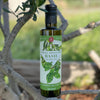 Bottle of Lucero Genovese Basil Olive Oil in a young olive tree.