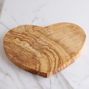 Well-figured Heart Shaped Olivewood Board, 8.5" shown on marble counter