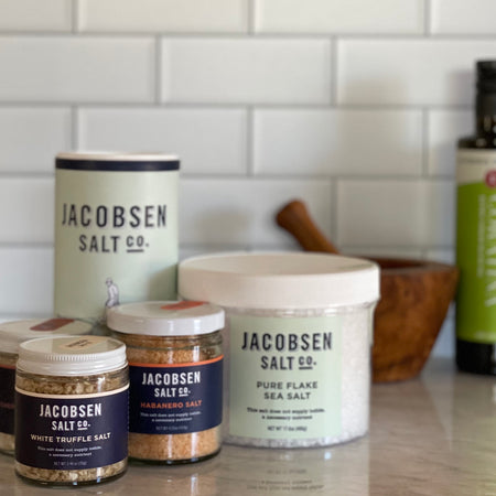 A grouping of various Jacobsen salts showing Habanero salt is a medium sized jar, slightly taller than truffle and cherrywood smoked salts