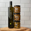 Large Bottle of Arbequina EVOO is shown next to three stacked jars of table olives, showing relative sizes