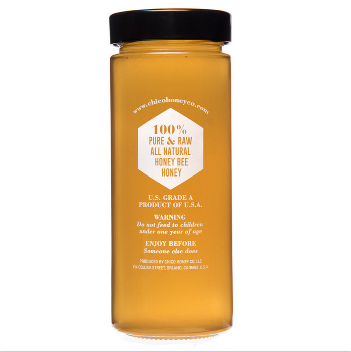 The back of the honey jar is shown and indicates that the product is 100% pure and raw, all natural honey bee honey.