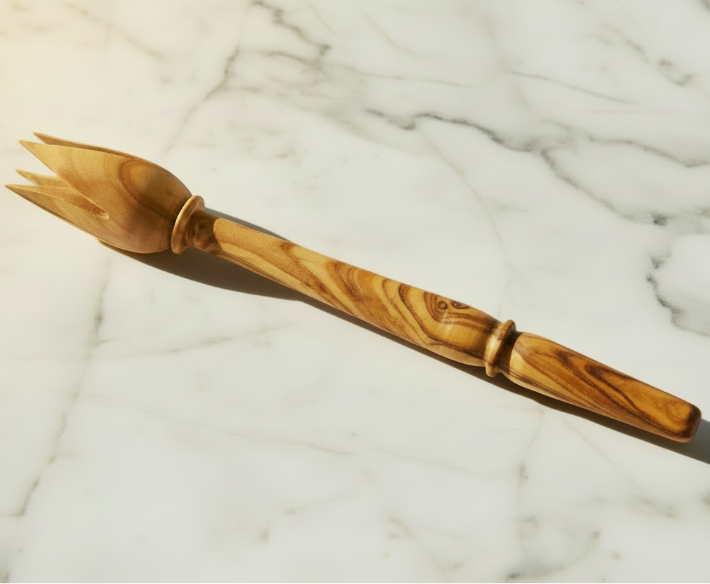 This traditional tool is used to pick up olives with a tulip shaped end comprised of four curved and pointed "petals".