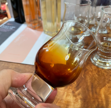 Liz uses official vinegar tasting glasses to assess and approve vinegar we offer. Our balsamic vinegar has exceptional viscosity as shown here.