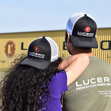 Two young people, backs to the camera and hats on backwards, stand in front of the old tasting room