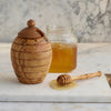 Olivewood honey pot is shaped like an old-fashioned English straw bee skep. Removable lid has a cut out for the accompanying honey dipper, whimsically shaped like a beehive on a stick.